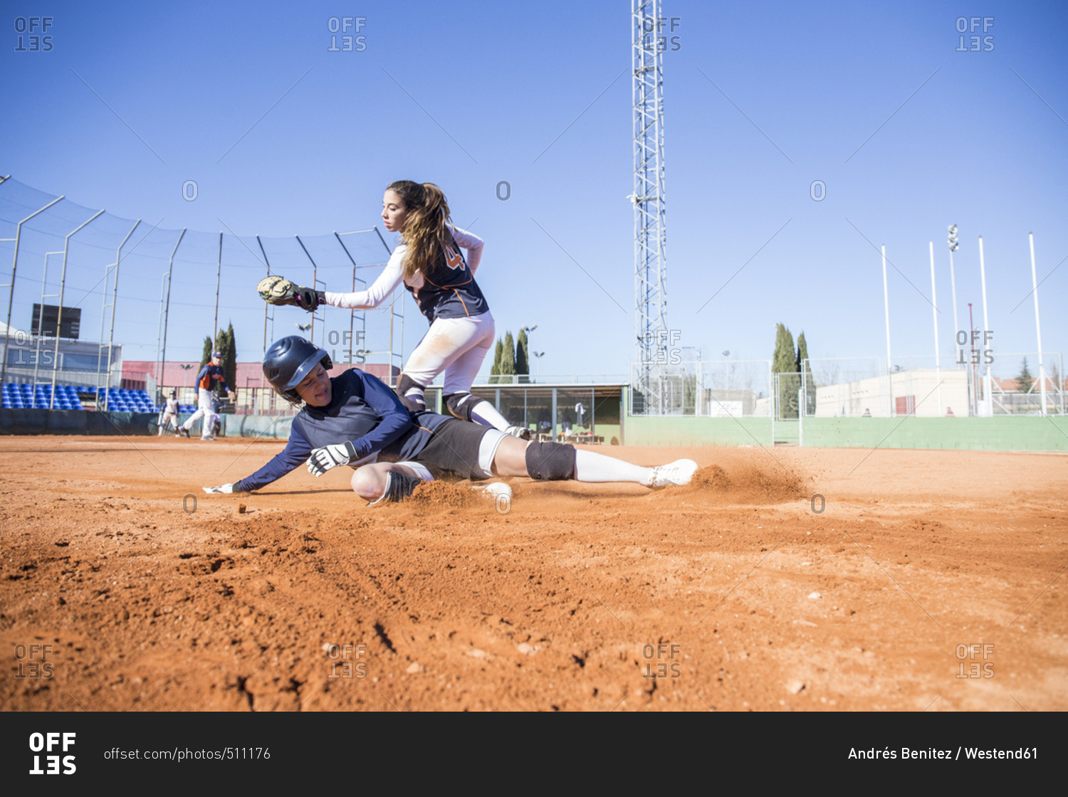 Baseball player sliding to the base during a baseball game