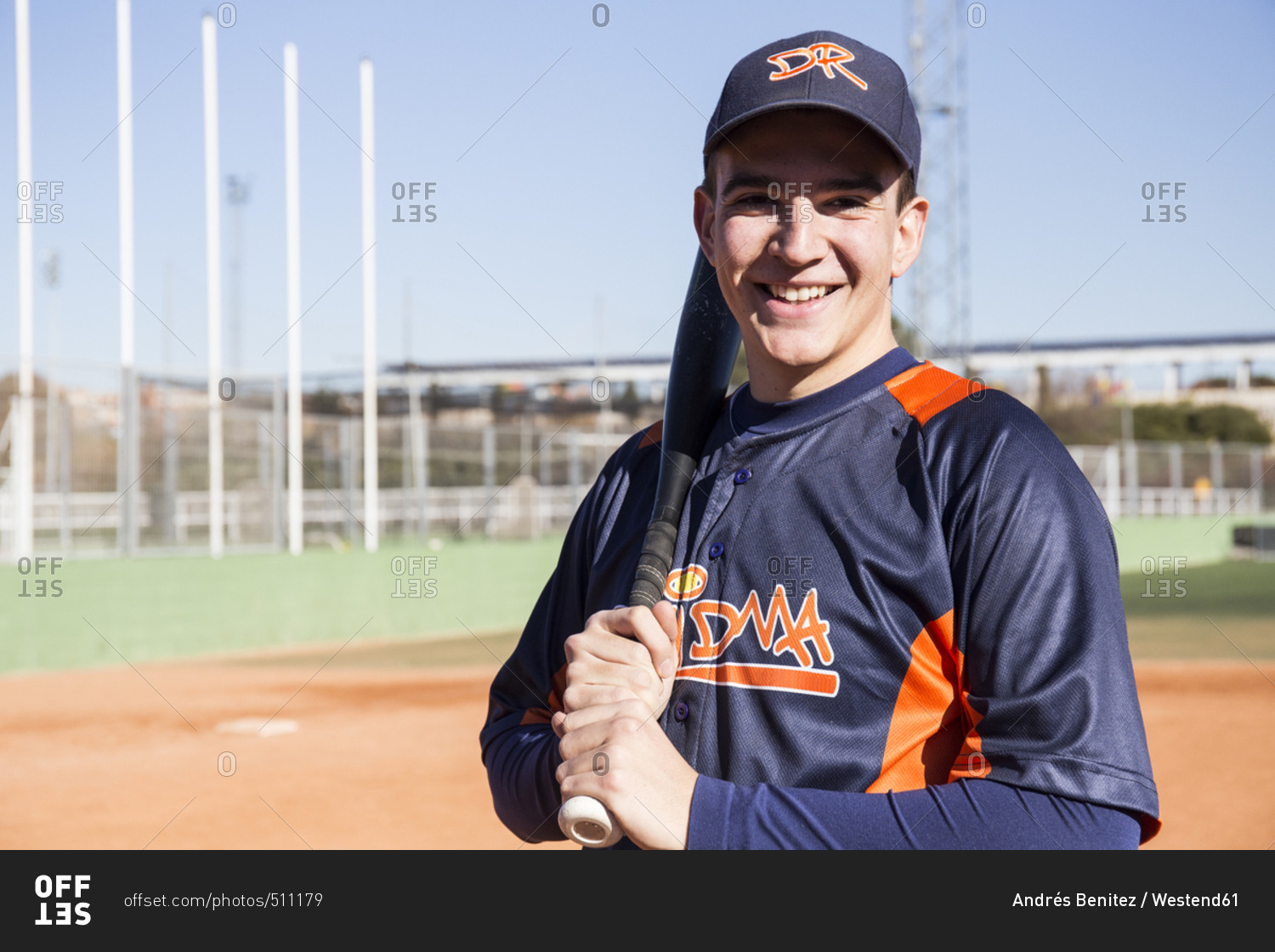 Portrait of smiling baseball player with a baseball bat