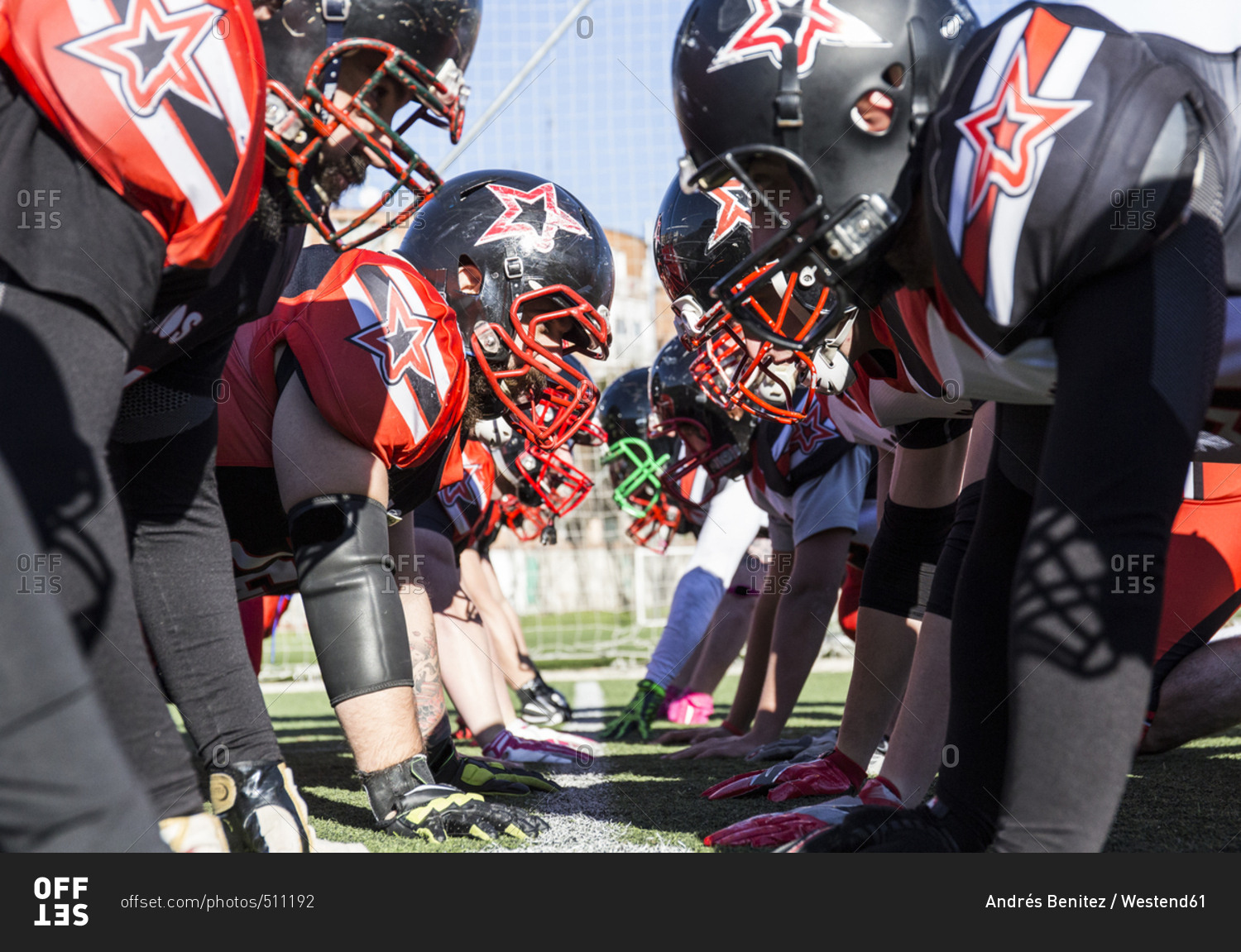 American football players on the line of scrimmage during a match stock