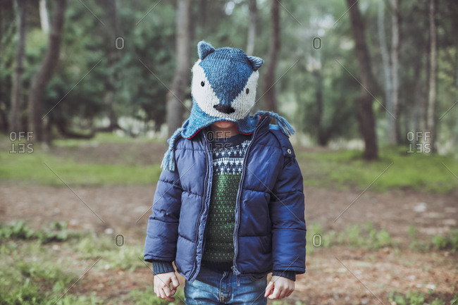 Boy wearing funny wooly hat in forest