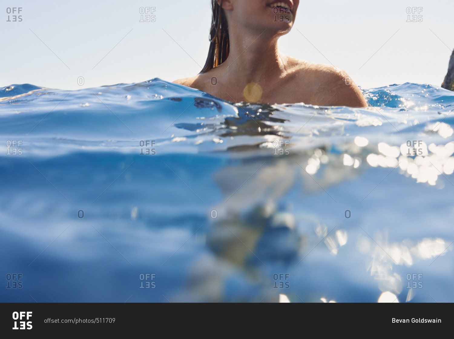 Underwater shot of beautiful girl swimming in deep blue sea from boat on wild free travel adventure vacation