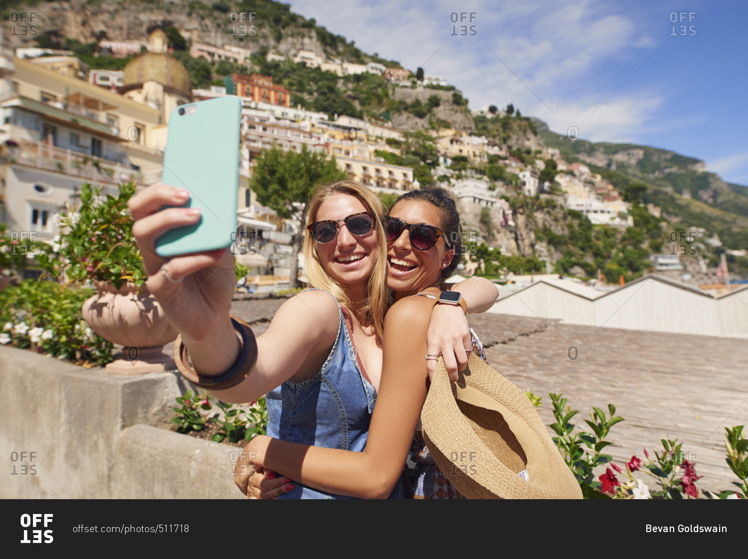 Tourist Girl Friends taking selfies  for social media with smart phone smiling on summer fun travel adventure in Amalfi