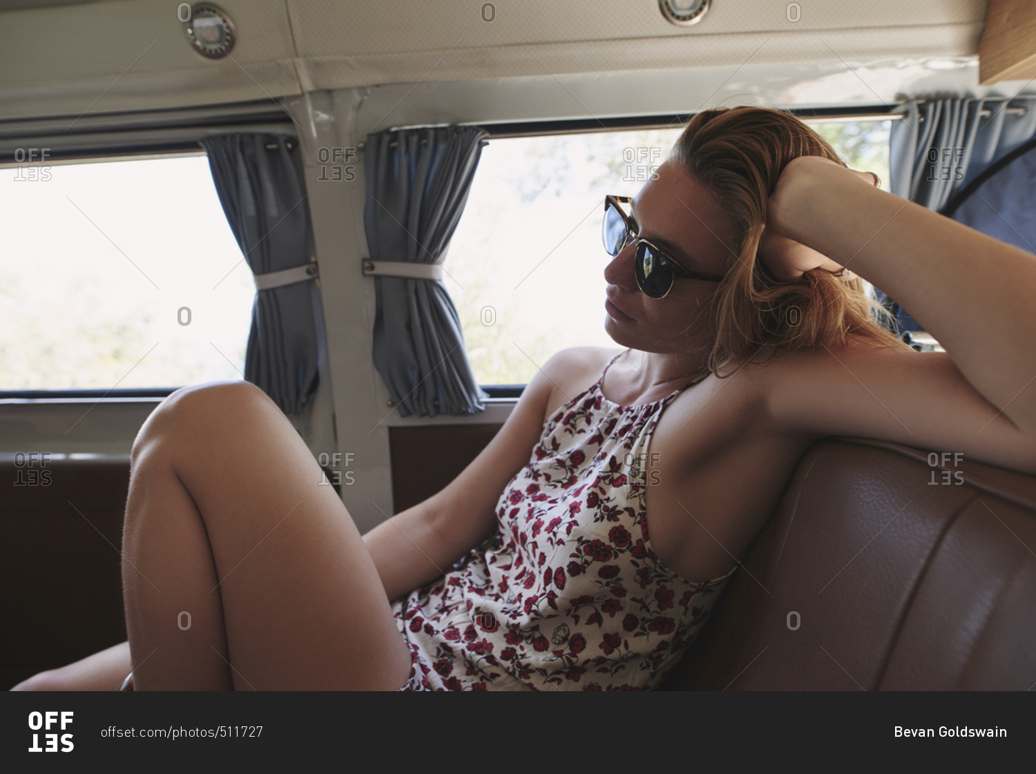 Beautiful Woman travelling in vintage camper van on adventure road trip