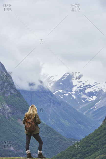 Travel adventure woman enjoying view of majestic glacial valley on exploration discover beautiful earth