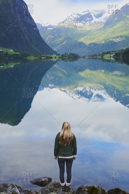 Adventure woman enjoying view of majestic mountain lake explore travel discover beautiful earth