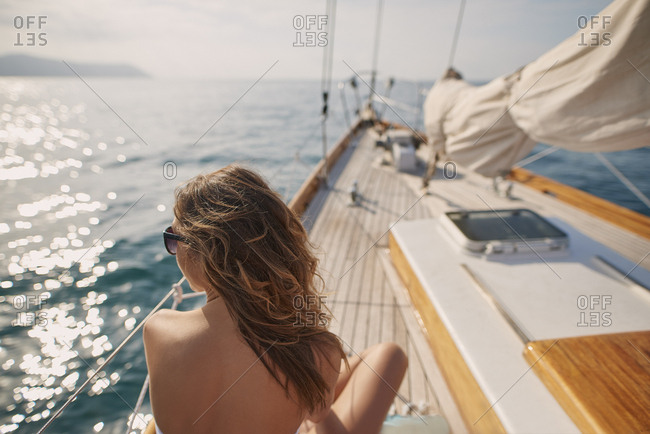 Beautiful Woman On Sailboat In Bikini In Ocean On Luxury Summer