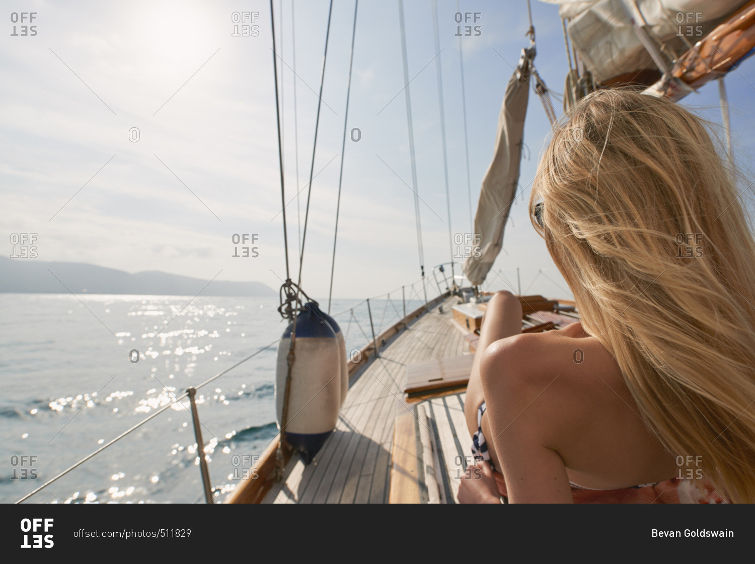 Beautiful woman on sailboat in bikini in ocean on luxury summer lifestyle happy adventure travel vacation