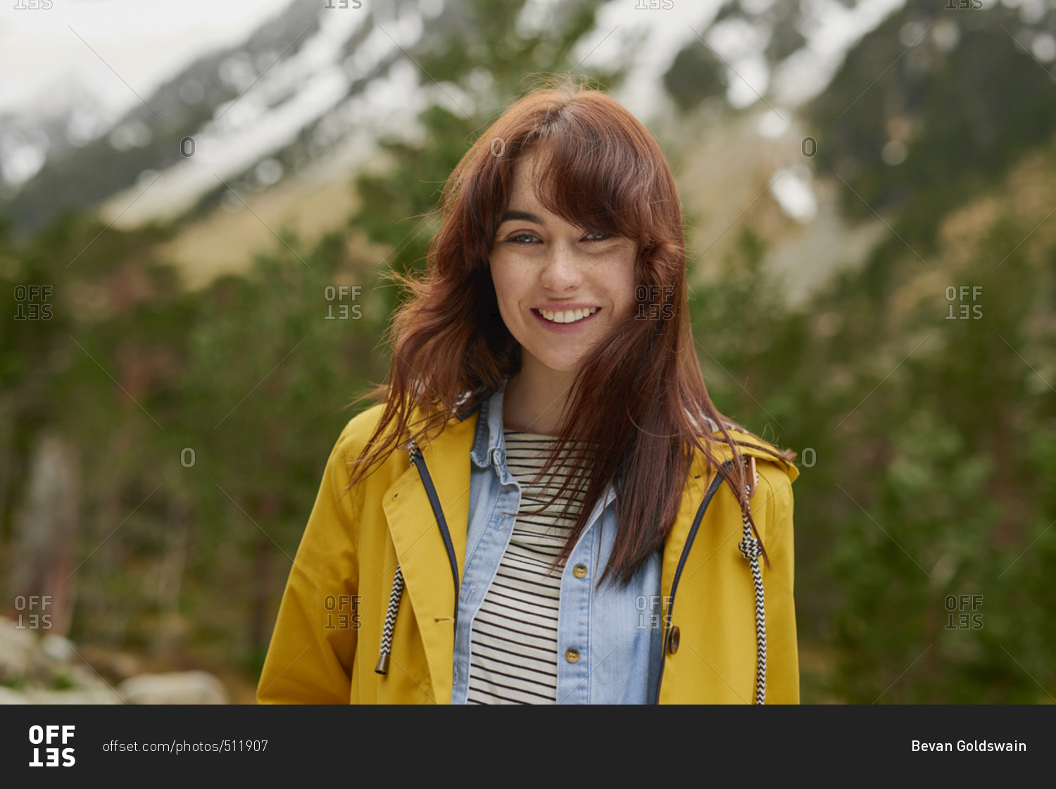 Portrait of Adventure travel hiker woman smiling  in beautiful green forest snow mountains on scenic outdoor vacation