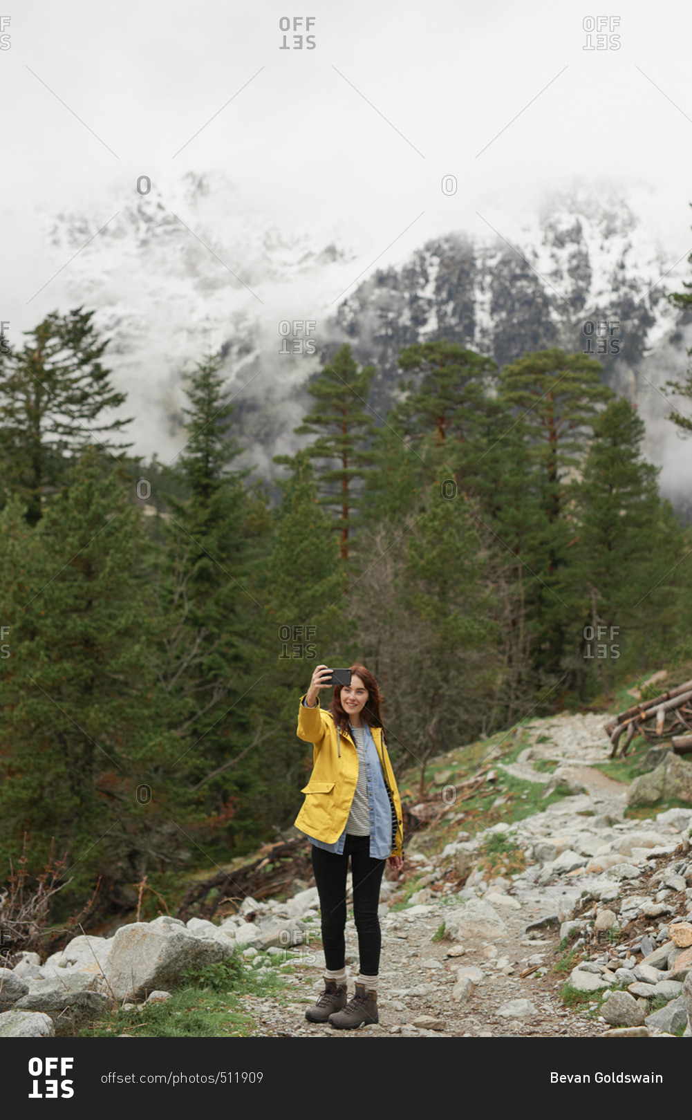 Travel adventure woman taking smart phone selfies on mountain enjoying beautiful nature landscape wanderlust