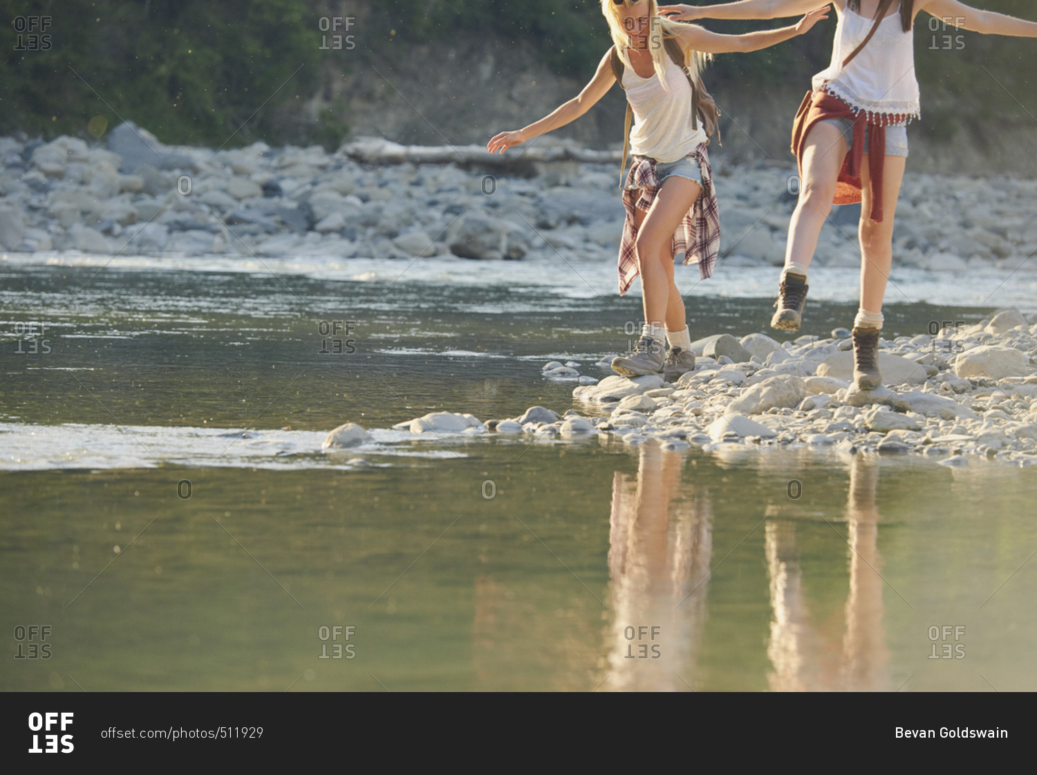 Adventure girl friends exploring river bank in countryside nature travel vacation
