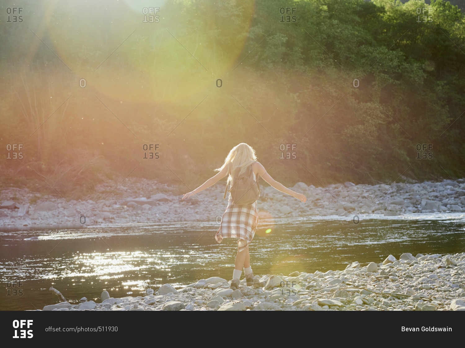 Adventure girl exploring river bank in countryside nature travel vacation sun flare