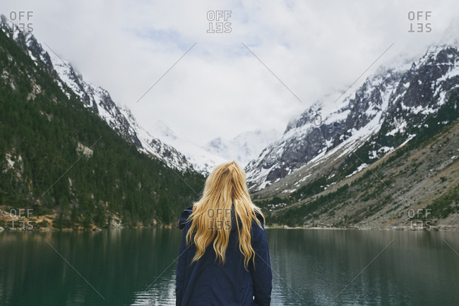 Travel adventure hiker woman on mountain lake enjoying beautiful nature landscape wanderlust