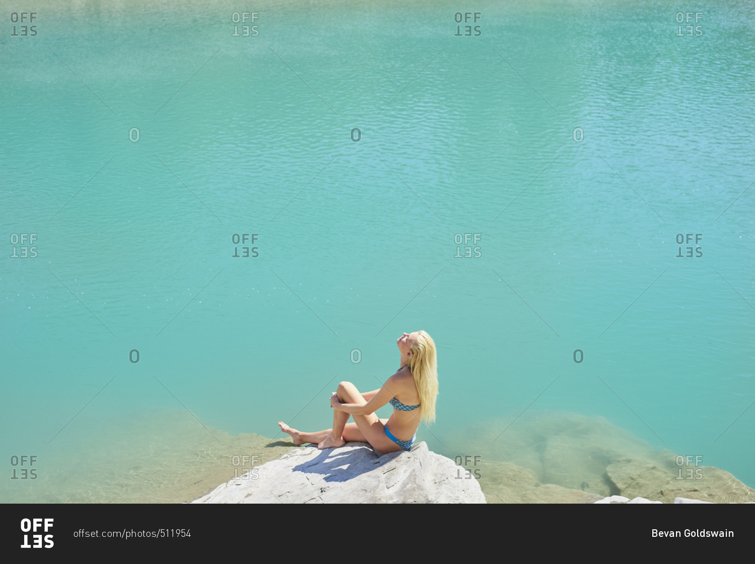 Beautiful girl tanning to wild swim in beautiful blue freshwater river on summer adventure vacation in nature