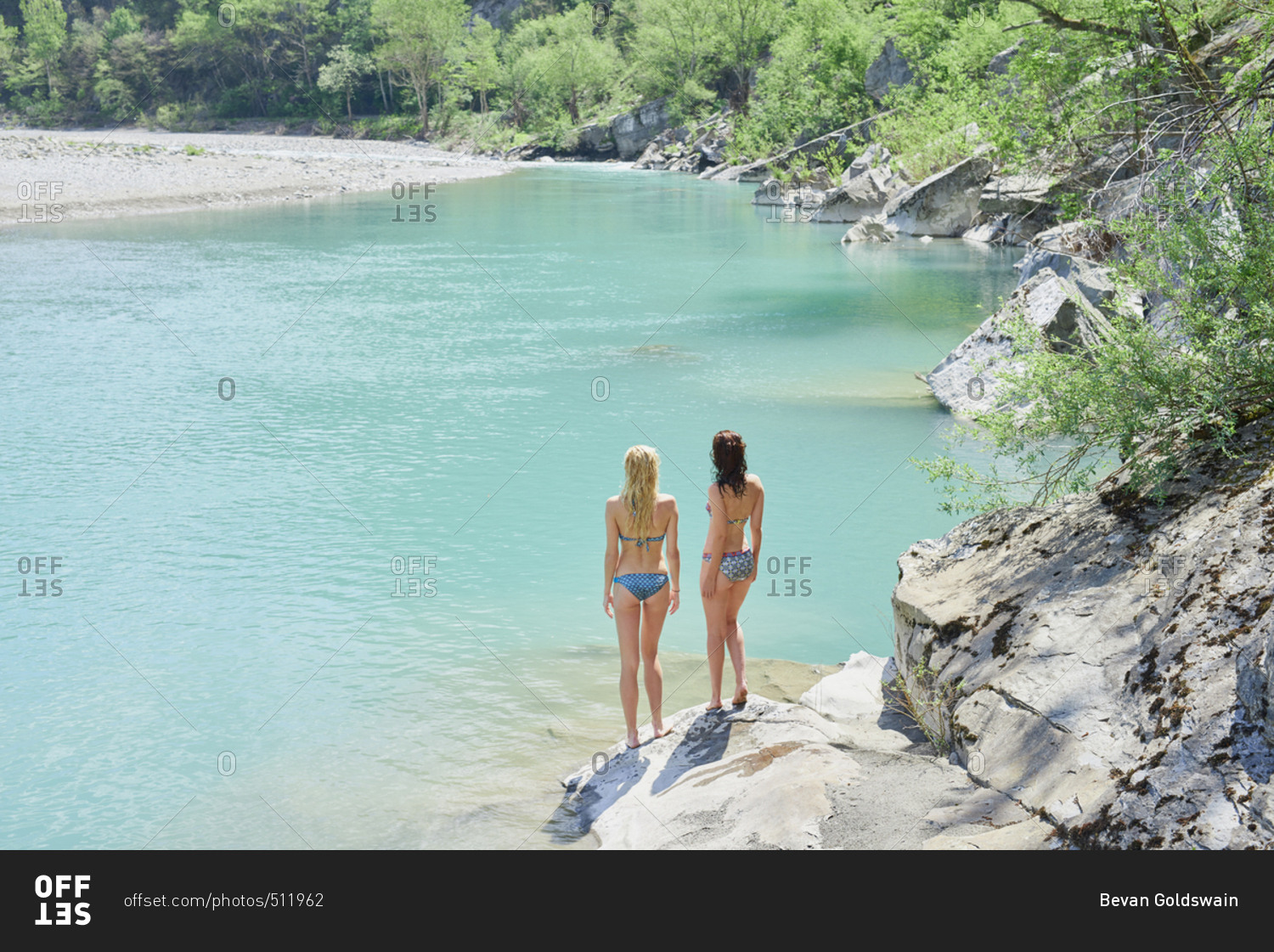 Adventure girl friends enjoying view of beautiful blue freshwater river stream wild landscape
