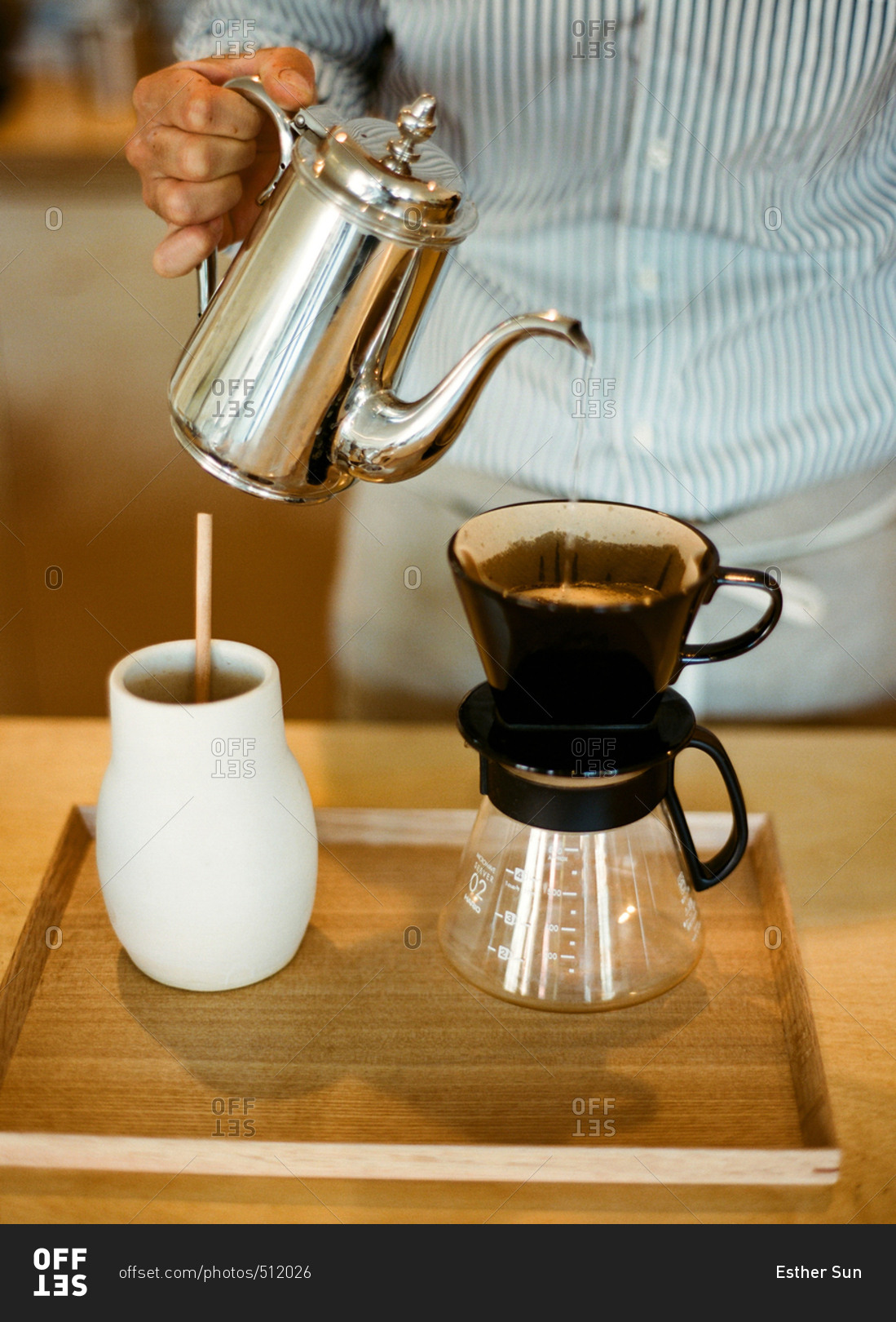 Man pouring hot water over coffee in a pour-over carafe