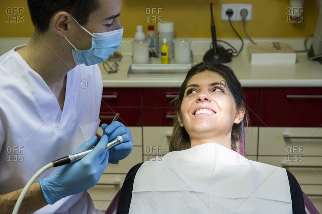 Smiling woman looking at dentist at medical clinic