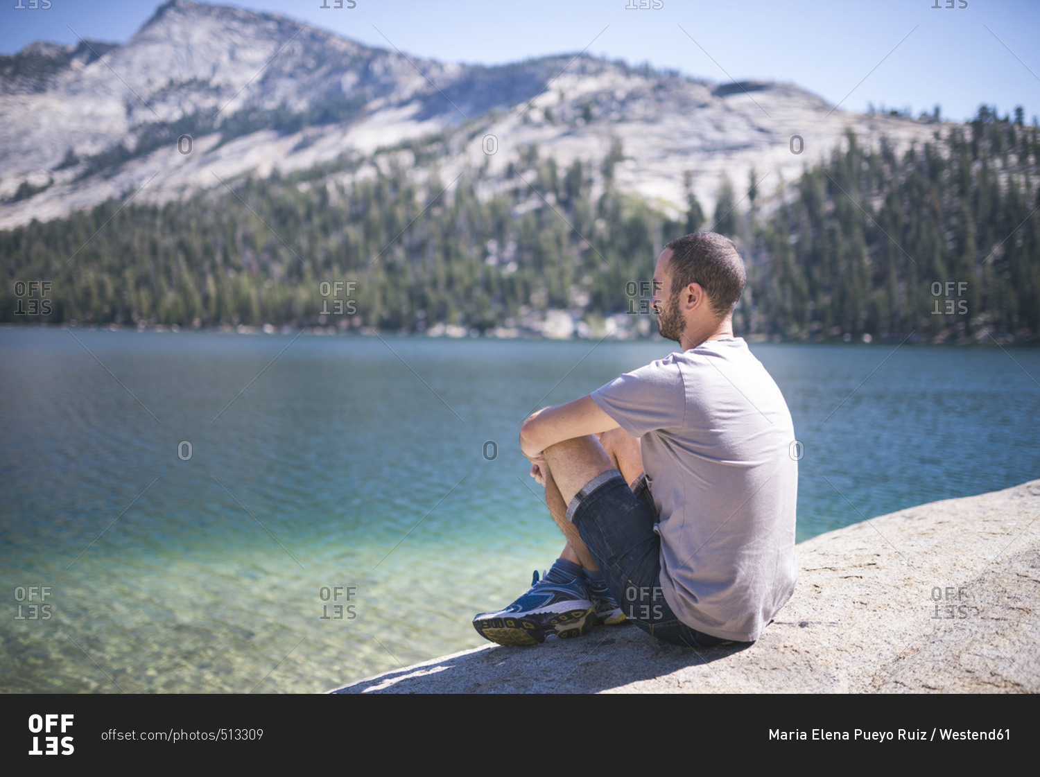 USA- California- Yosemite National Park- man sitting at mountain lake