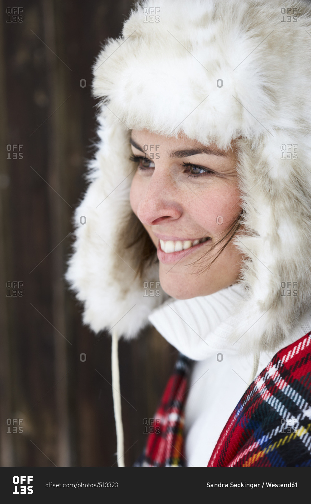 Portrait of smiling woman wearing fur cap in winter
