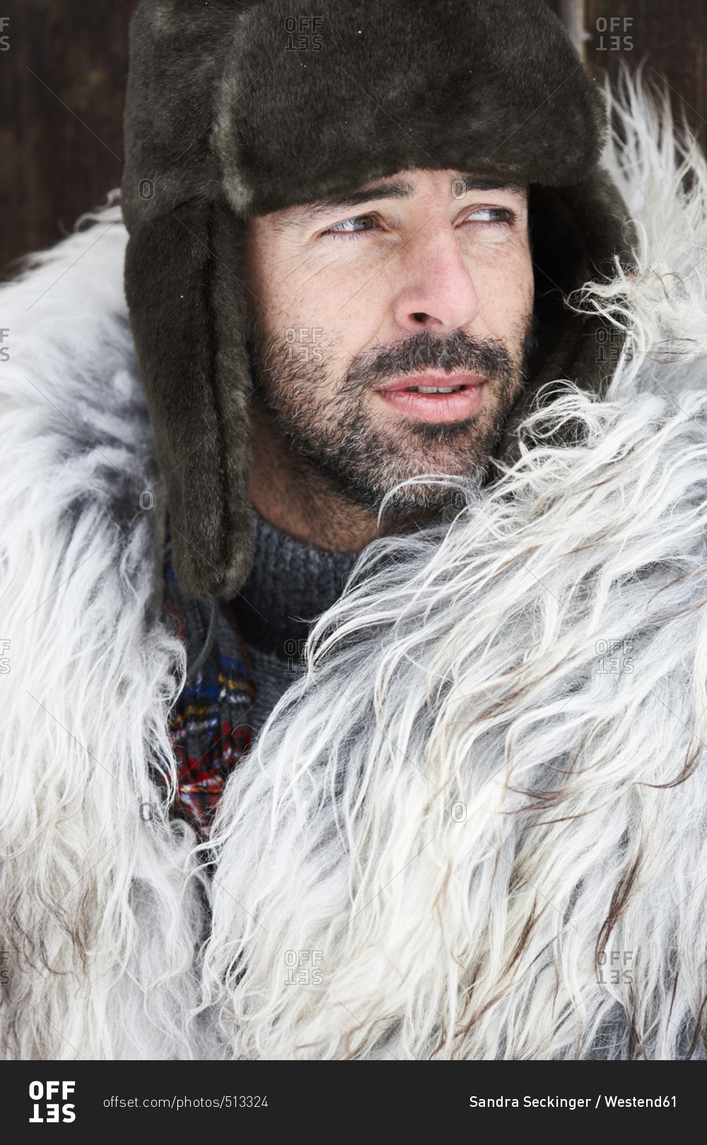 Portrait of man wearing fur cap in winter