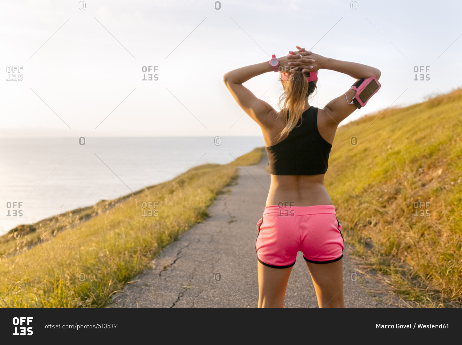 Young woman looking at the sea after workout