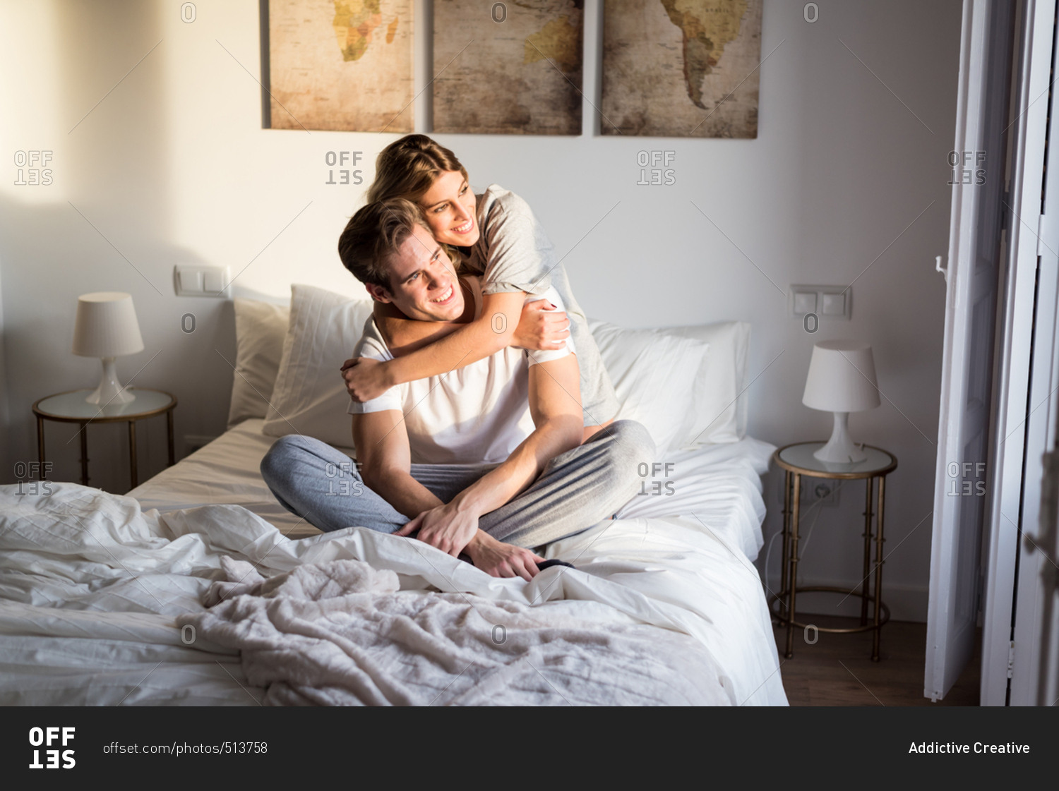 Happy young couple relaxed at home on bed