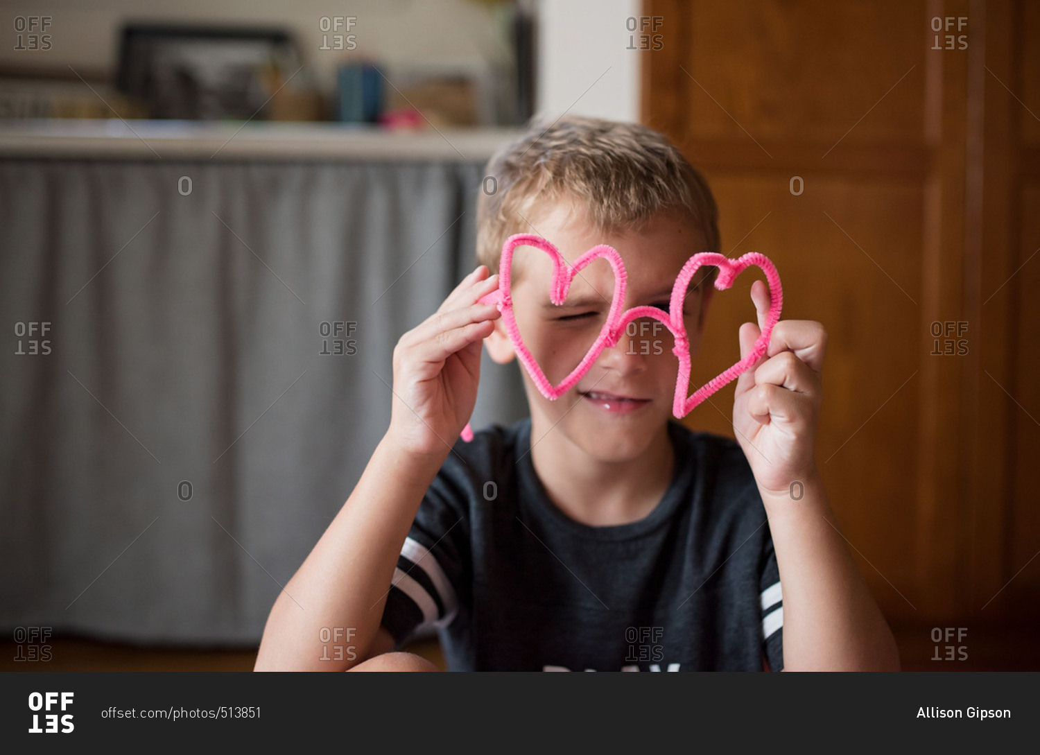 Boy making heart shapes with pipe cleaners