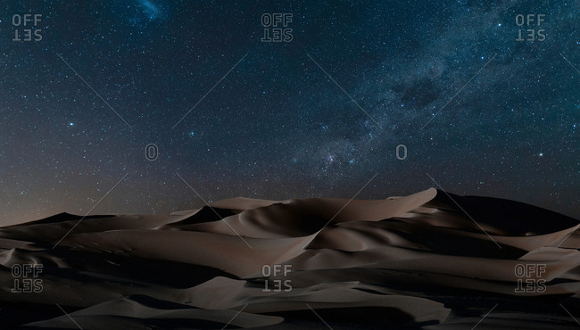 View of dunes under starry night sky, Namib Desert, Namibia
