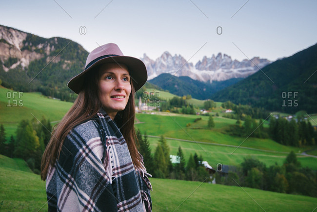 Woman looking into distance, Santa Maddalena, Dolomite Alps, Val di Funes (Funes Valley), South Tyrol, Italy