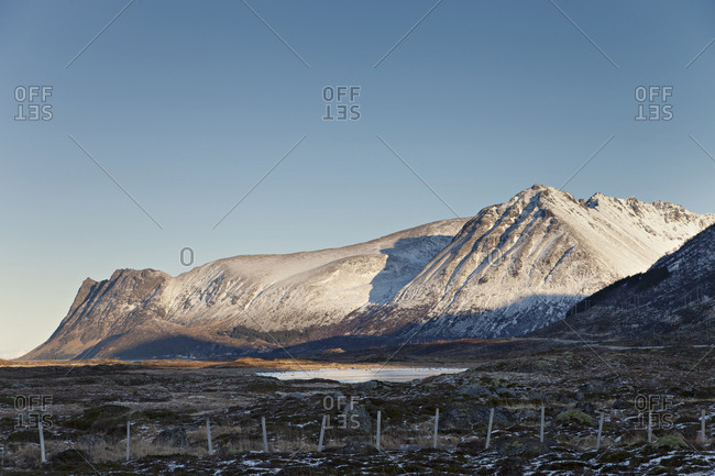 Distant snow-covered mountains illuminated by the setting sun