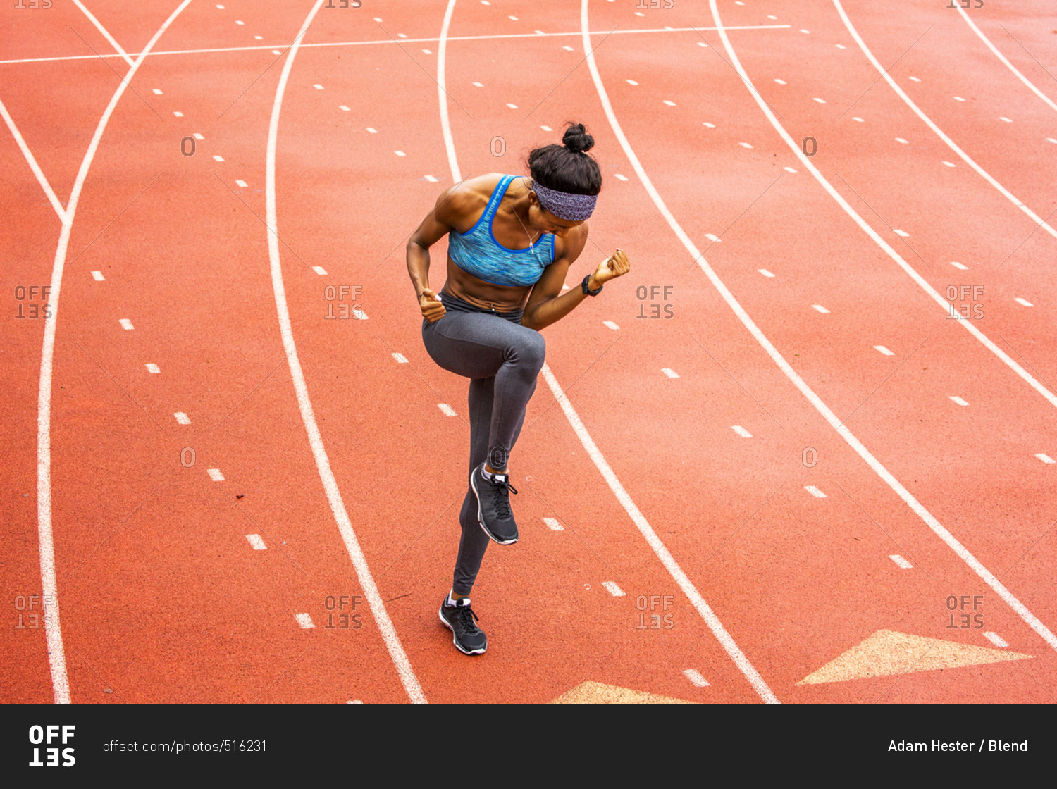 Happy Black athlete celebrating on track stock photo - OFFSET