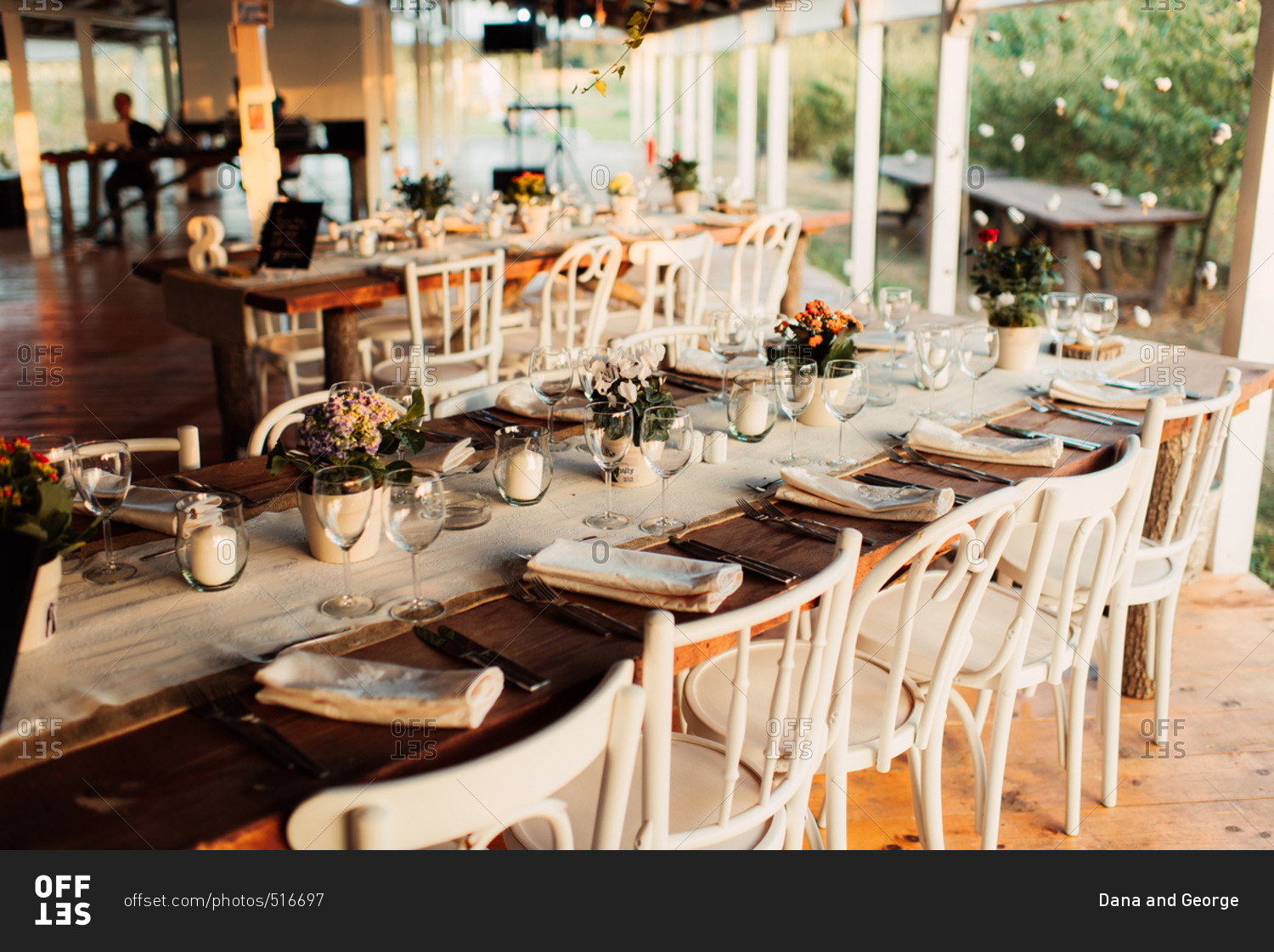 Rustic tables with burlap table runner at a wedding reception
