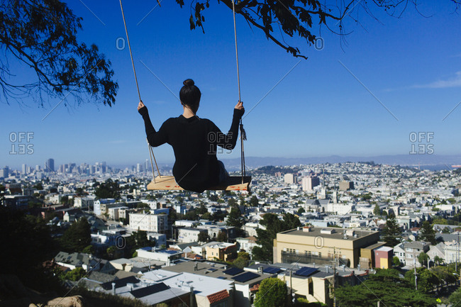 Woman swings over San Francisco, California