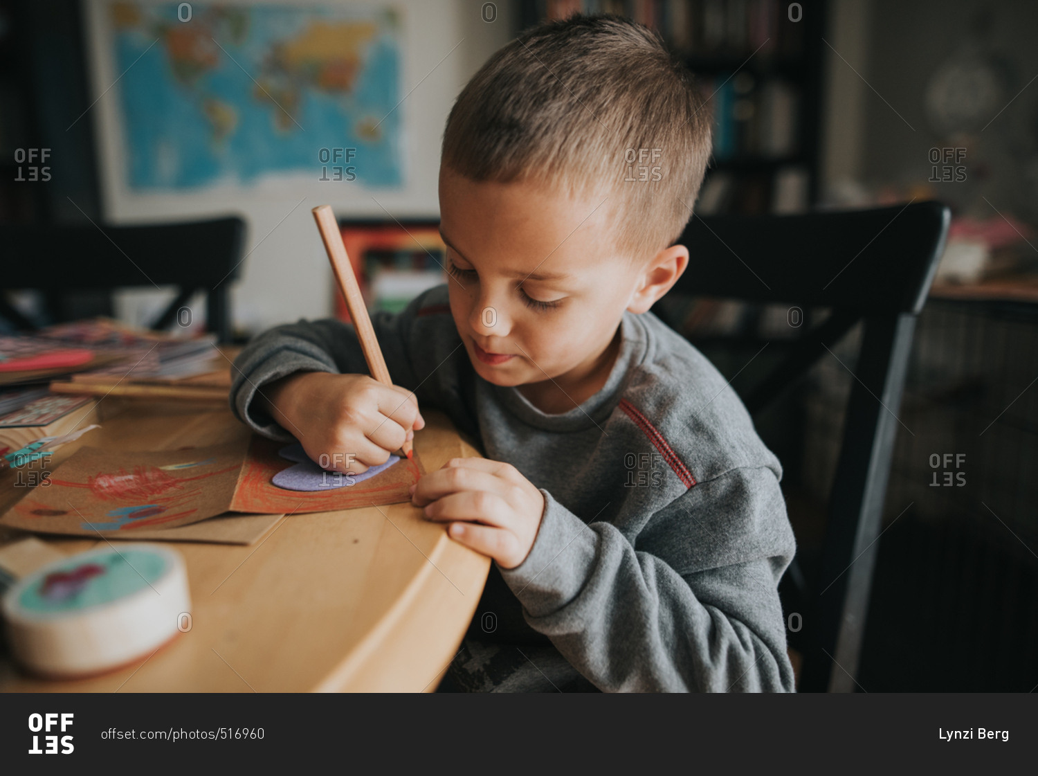 Young boy coloring a Valentine's day card