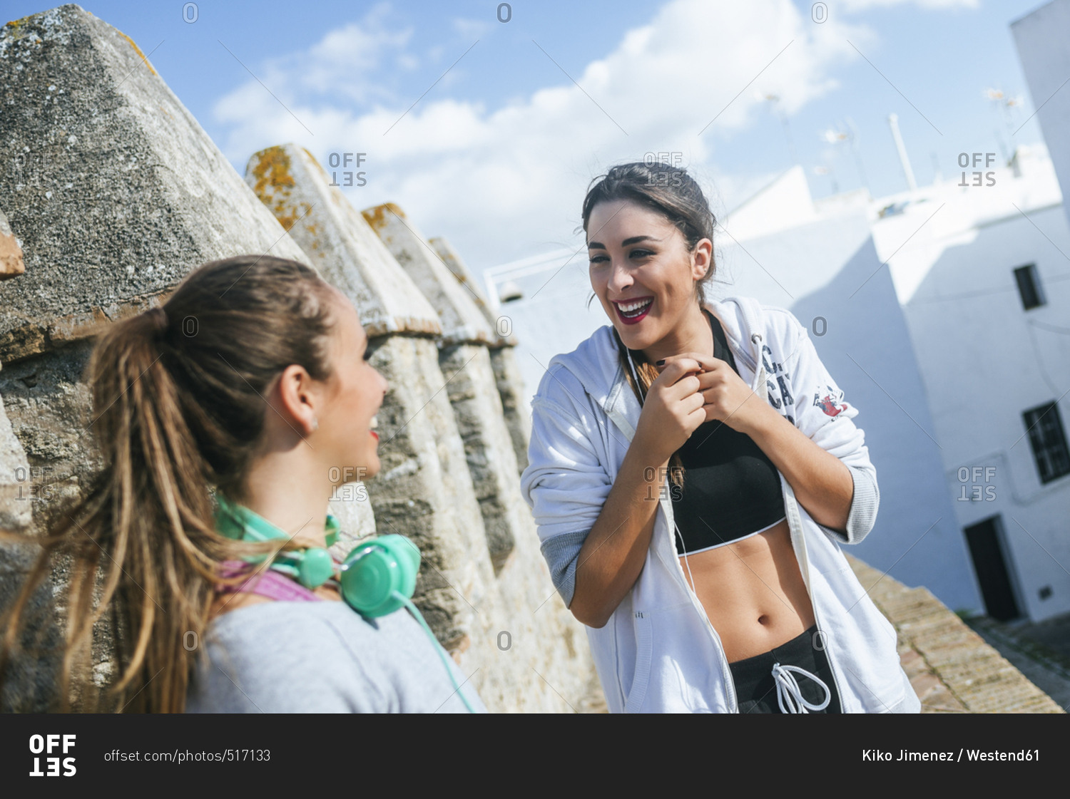 Two friends talking in the street after workout