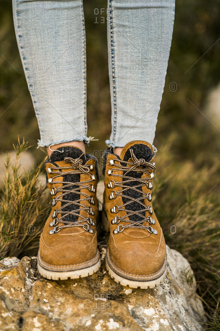 Woman wearing hiking boots standing on a rock