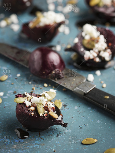 Beetroots with cheese and knife on table