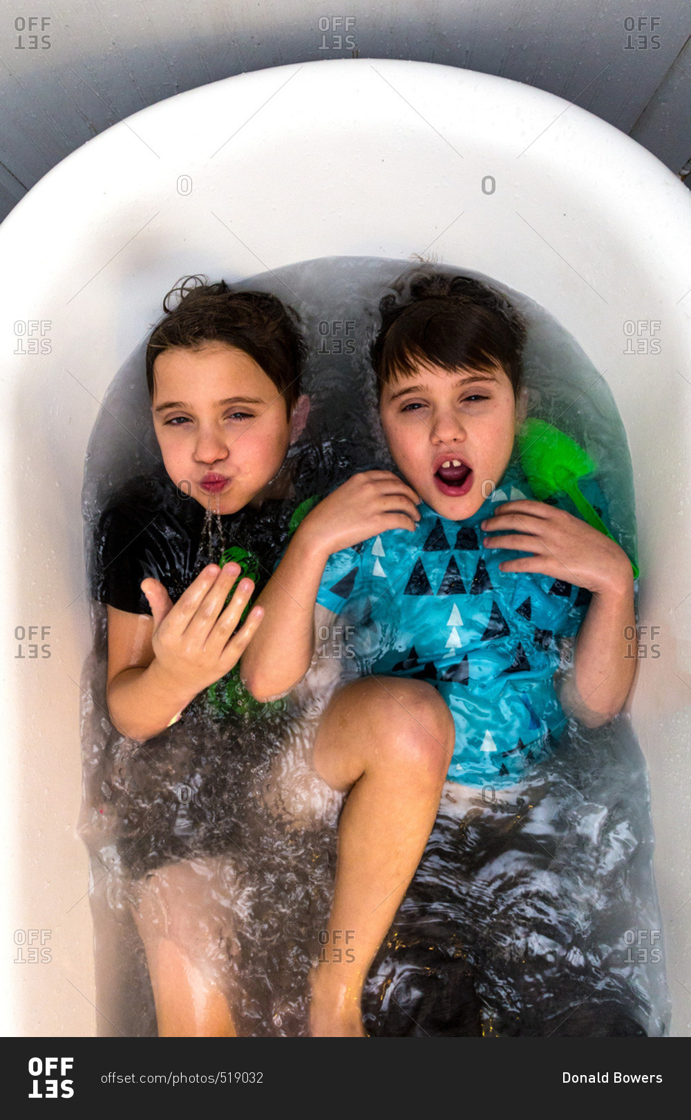 Twin Caucasian Brothers Play In Their Water Filled Bathtub Together 