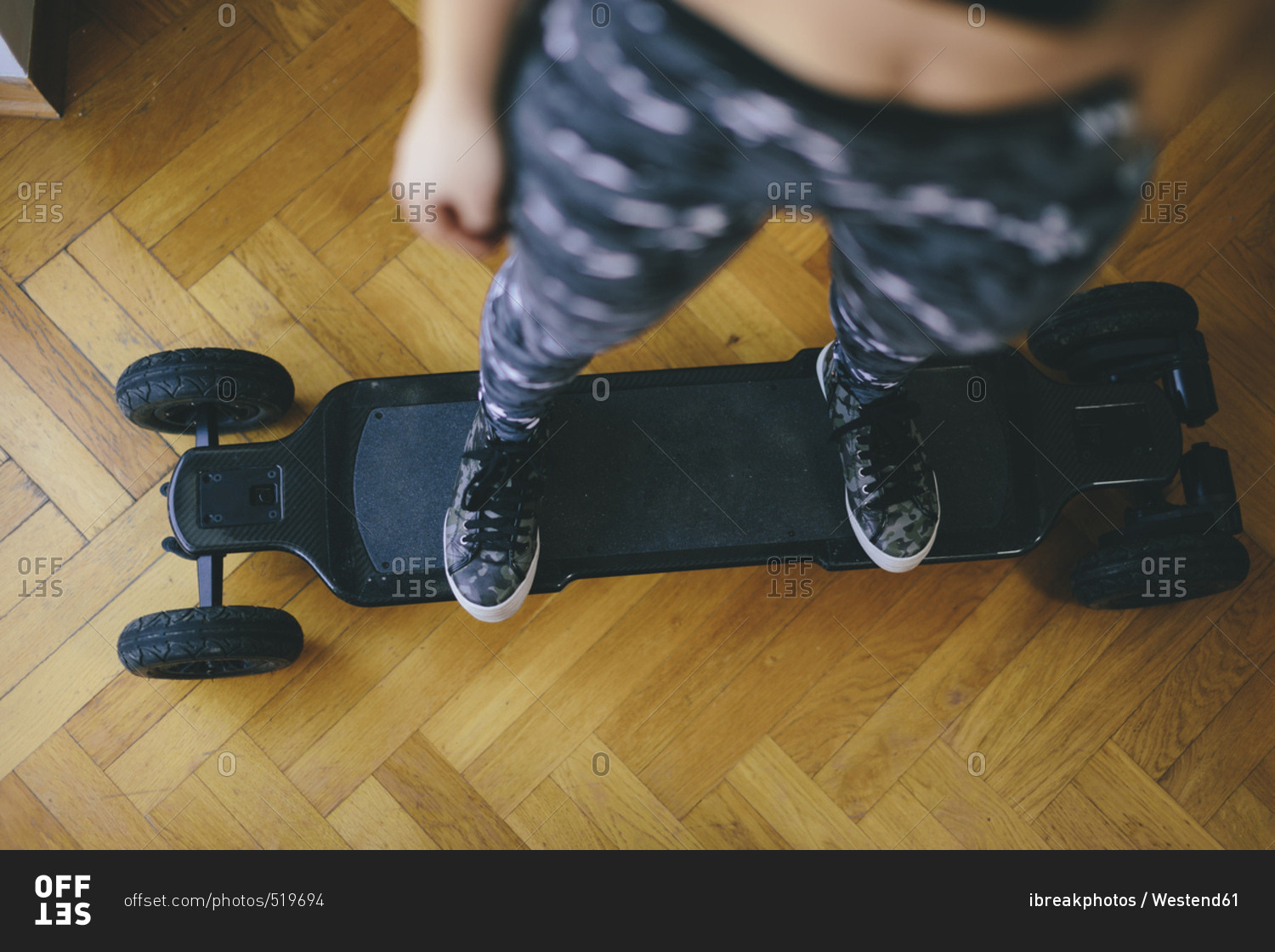 Young woman standing on electric skateboard