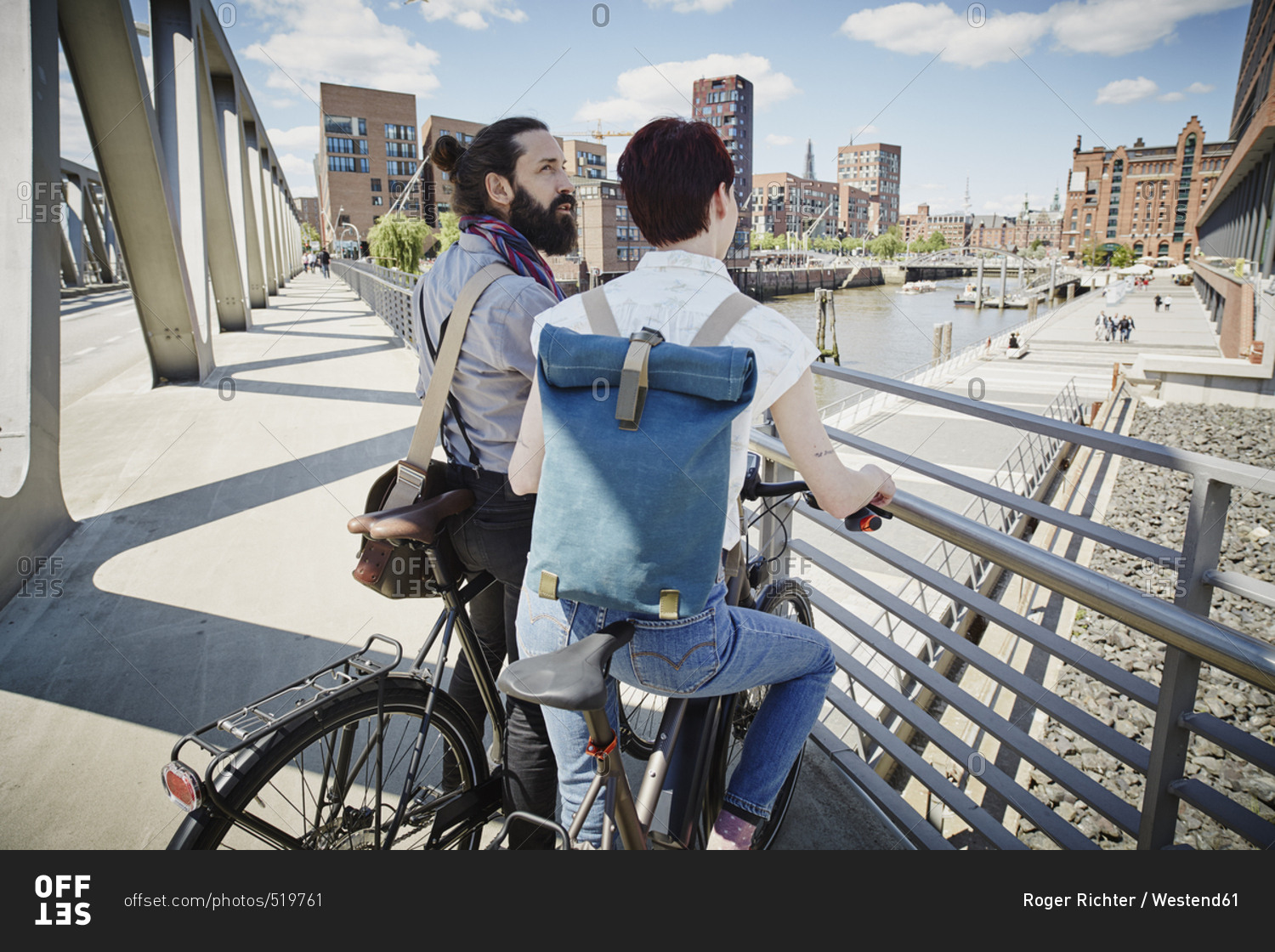 Germany- Hamburg- couple with electric bicycles on a bridge