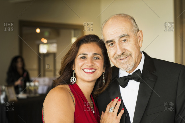 Hispanic father and daughter smiling at party