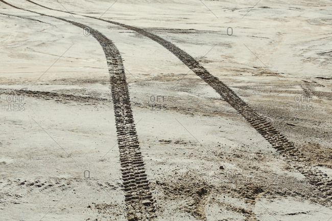 Tire tracks on the surface of the desert, parallel tracks.