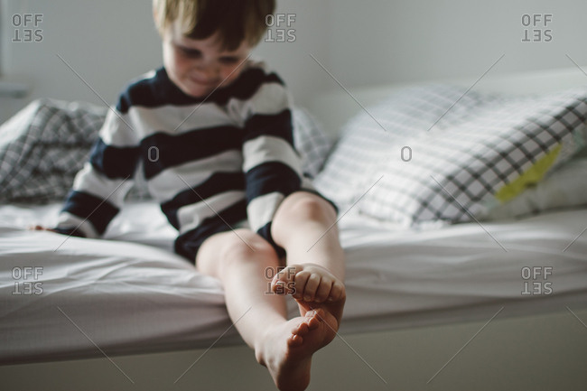 Little Boy Getting Out Of Bed In The Morning Stock Photo Offset