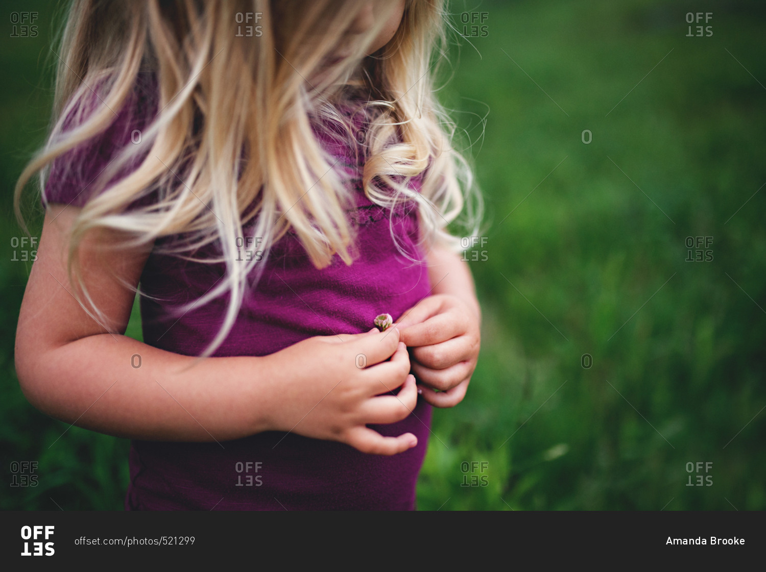 Girl holding small flower outside