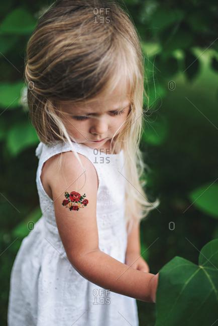 Girl with temporary tattoo on arm