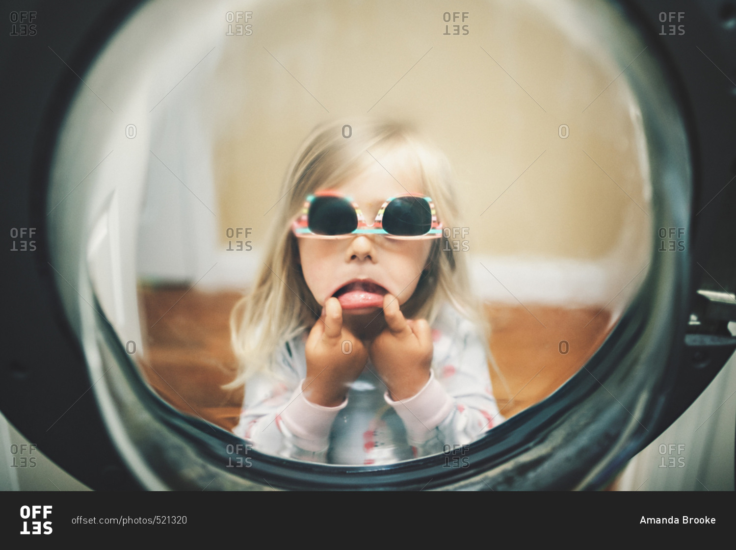 Girl Making Face In Washing Machine Door Stock Photo OFFSET
