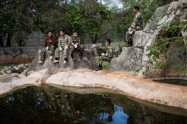 Kanchanaburi, Thailand - June 2, 2016: Wildlife officers waiting in tiger enclosure