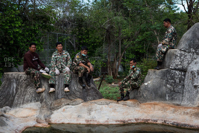 Kanchanaburi, Thailand - June 2, 2016: Wildlife officers waiting in a tiger enclosure