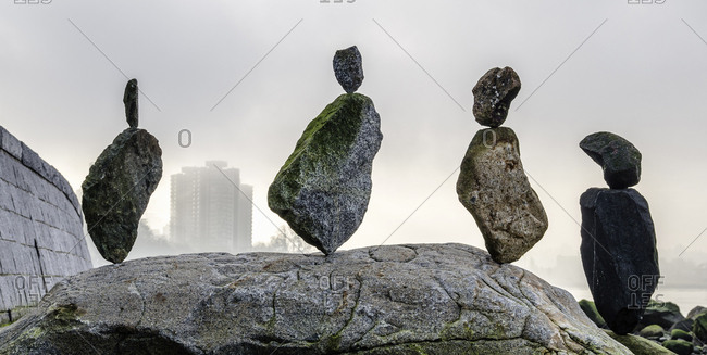 A row of boulders and balanced stones on the sea shore.