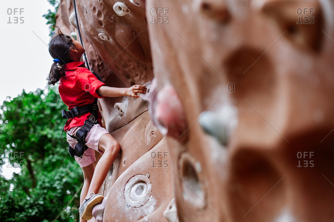 May 30, 2013 - Nainital, Uttarakhand, India: Young woman practicing on outdoor climbing wall
