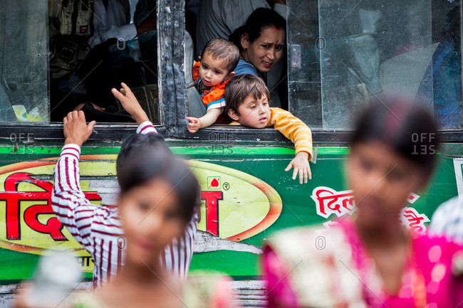 June 10, 2013 - Nainital, Uttarakhand, India: Mother and young children in the window of a bus